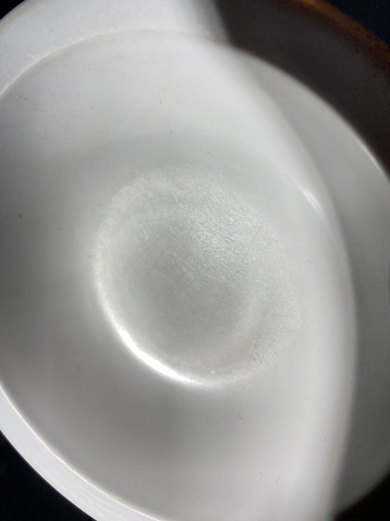 May include: A white ceramic bowl with a smooth, slightly textured surface. The bowl is empty and appears to be brand new.