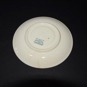May include: White ceramic saucer with a green printed mark on the bottom that reads "Made in England, Crown Staffordshire, England".