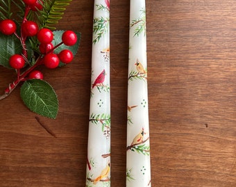 Pair of 10” Hand Painted Ivory Taper Candles - male and female cardinals, pine cones and pine boughs