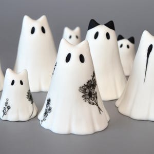 Escultura fantasmal de cerámica con forma de pequeño gato fantasma.
