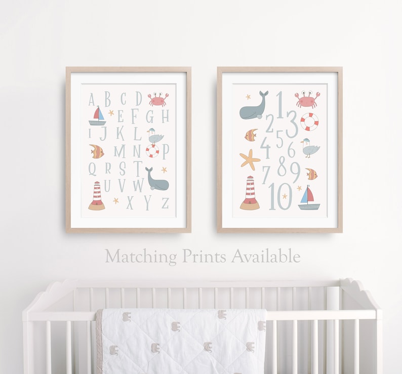 May include: Two framed prints with a nautical theme. The first print features the alphabet with a different sea creature or nautical object next to each letter. The second print features the numbers 1-10 with a different sea creature or nautical object next to each number.