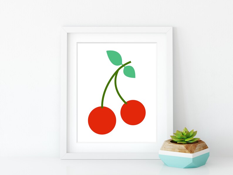 May include: A white framed print with a simple illustration of two red cherries with green stems and leaves.
