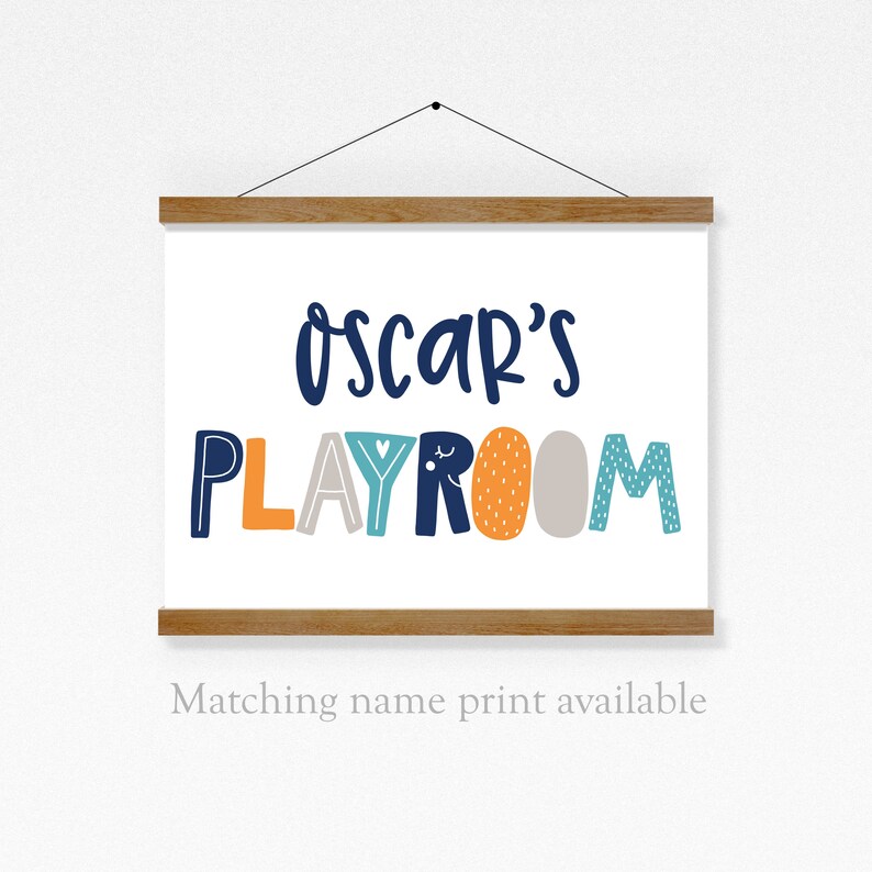 May include: A white canvas print with the text "Oscar's Playroom" in colorful, stylized letters. The letters are in shades of blue, orange, yellow, and gray.