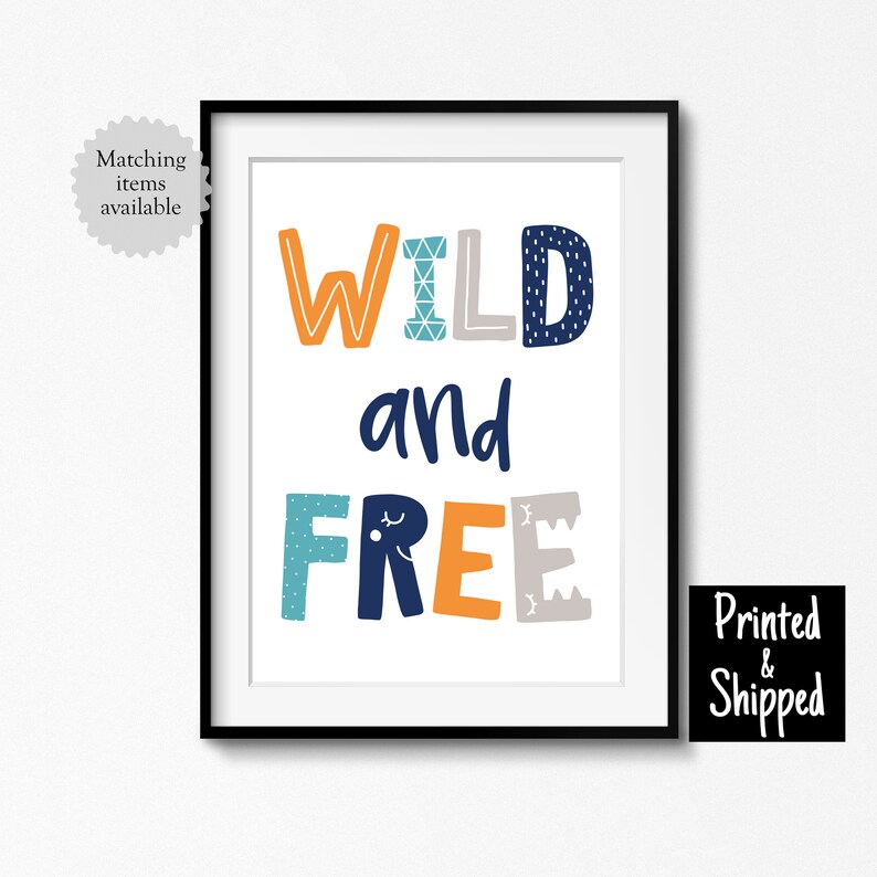 May include: A framed print with the text "WILD and FREE" in colorful, patterned letters. The letters are in shades of blue, orange, and gray.
