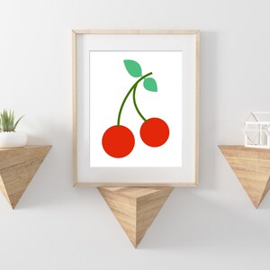 May include: A framed print of a minimalist illustration of two red cherries with green stems and leaves on a white background.