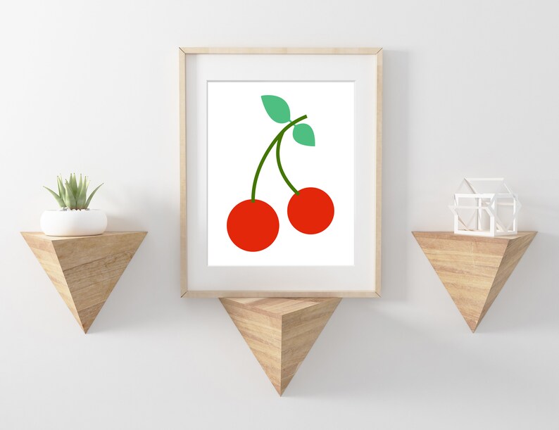 May include: A framed print of a minimalist illustration of two red cherries with green stems and leaves on a white background.