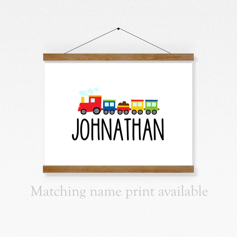 May include: A colorful train with a red engine and multiple cars, with the name "JOHNATHAN" printed below. The train is on a white background.