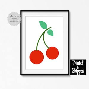 May include: A framed print of a simple illustration of two red cherries with green stems and leaves on a white background.
