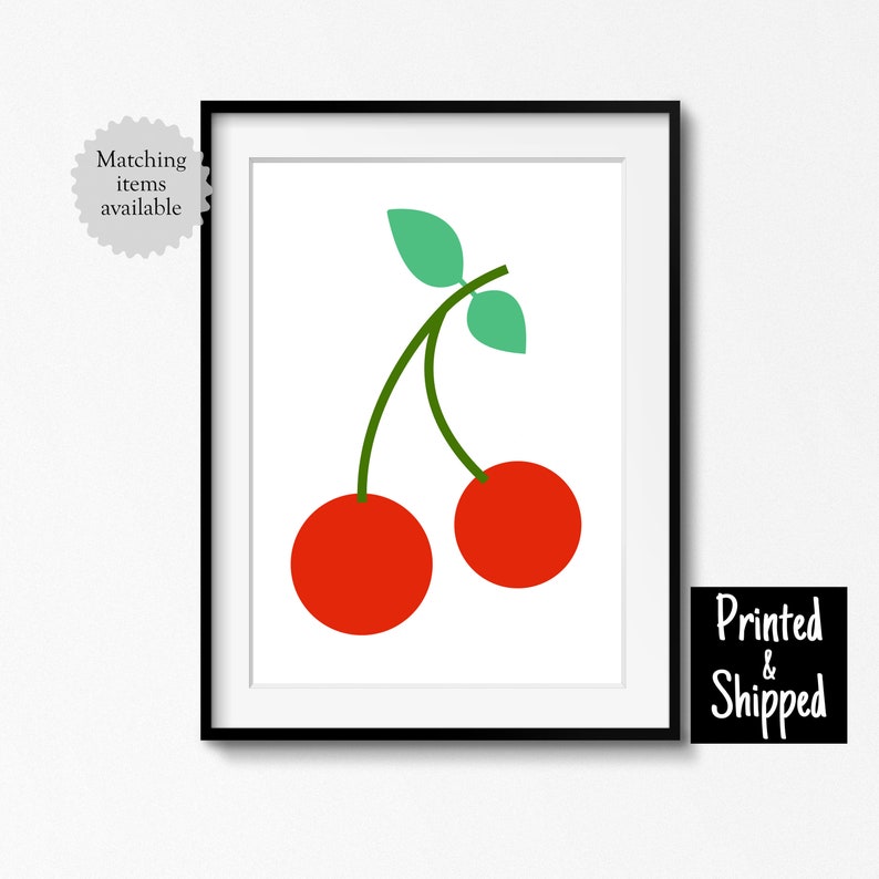 May include: A framed print of a simple illustration of two red cherries with green stems and leaves on a white background.