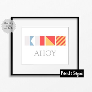 May include: A nautical themed print featuring four colourful signal flags spelling out the word "AHOY" in grey text.