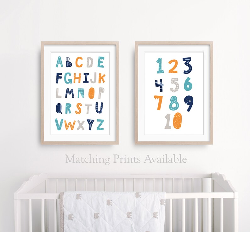 May include: Two framed prints with a white background. The left print features the alphabet in blue, orange, and gray letters. The right print features the numbers 1-10 in blue, orange, and gray numbers.