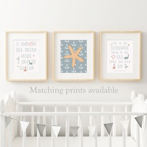 May include: Three framed prints with nautical themes. The left print has a quote about sailing, the middle print has a starfish on a blue background with anchors, and the right print has a quote about the sea and sunshine.