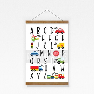 May include: A colorful alphabet chart featuring vehicles and transportation. Each letter of the alphabet is paired with a vehicle, such as a car, helicopter, ambulance, and train. The chart includes the words "Too!", "Whir", "Beep", "Choo Choo", "Ahoy Matey", "Loom", and "Stop".