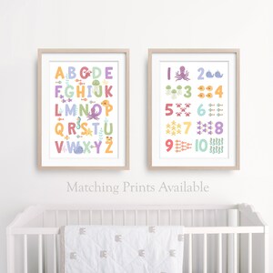 May include: Two framed prints with a white background and colorful illustrations. The left print features the alphabet with sea creatures. The right print features numbers 1-10 with sea creatures. The text below the prints reads "Matching Prints Available".