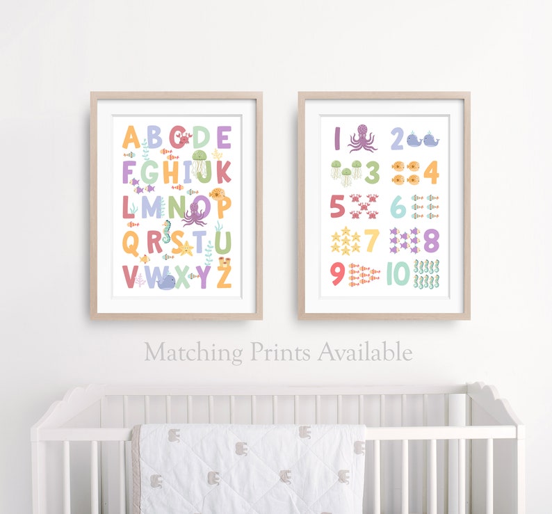 May include: Two framed prints with a white background and colorful illustrations. The left print features the alphabet with sea creatures. The right print features numbers 1-10 with sea creatures. The text below the prints reads "Matching Prints Available".