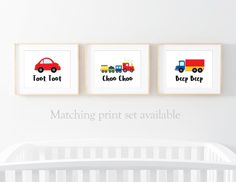 May include: Three framed prints with illustrations of a red car, a train, and a truck. The prints have the text "Toot Toot", "Choo Choo", and "Beep Beep" underneath the illustrations.