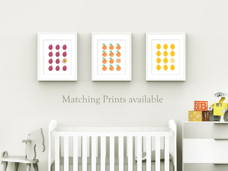 May include: Three white framed prints with a grid of fruit illustrations. The prints feature plums, oranges, and lemons. One fruit in each grid is cut in half to show the inside.