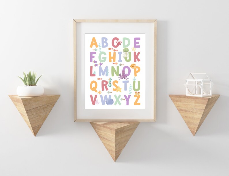 May include: A colorful alphabet poster with sea creatures. The letters are in a rainbow of colors and each letter has a different sea creature next to it. The poster is framed in a light wood frame.