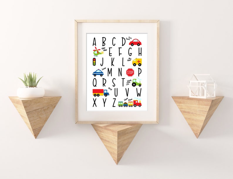 May include: A white alphabet chart with colorful illustrations of vehicles for each letter. The letters are in black and the illustrations include a helicopter, traffic light, car, ambulance, truck, tractor, train, and a red car.