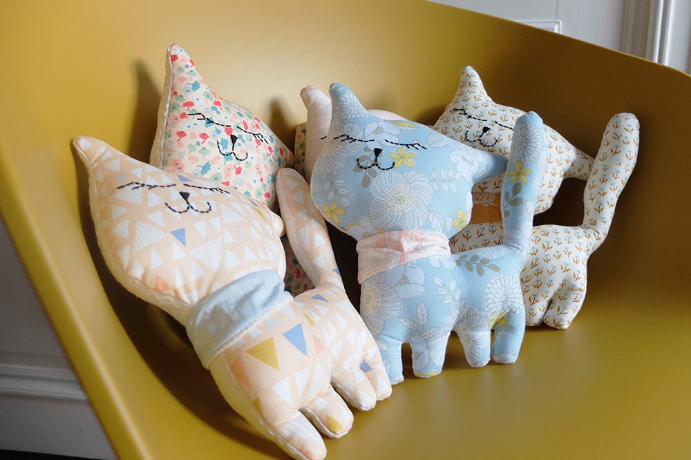 Chat Coussin en Tissu, Décoration Pour Bébé ou Enfant, Tissu Imprimé de Petits Triangles Pastels.