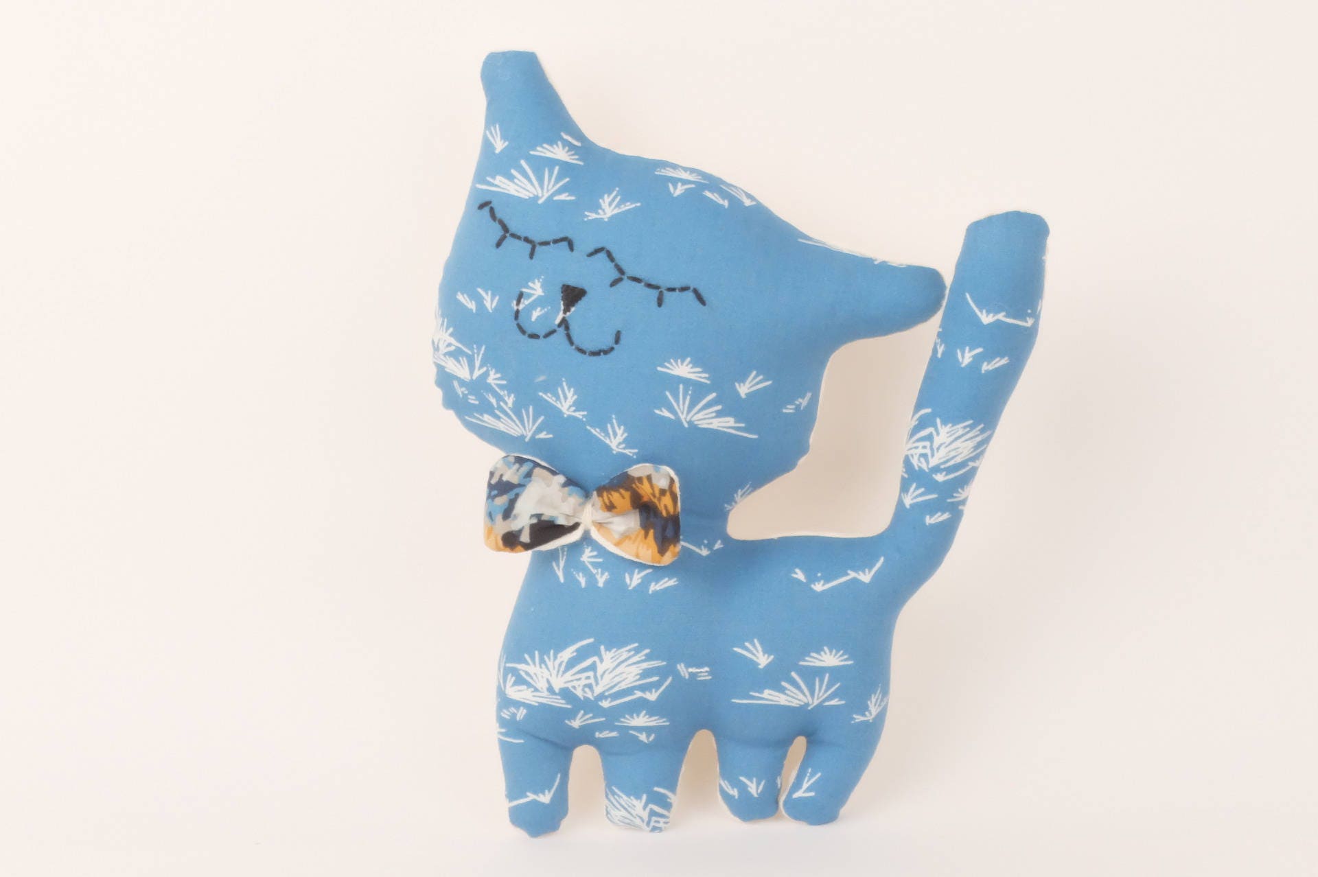 Chaton, Chat Doudou Décoratif en Forme de Petit Chat, Imprimé Petites Herbes sur Fond Bleu.