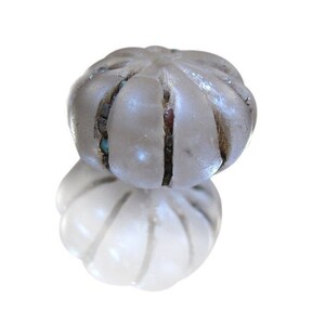May include: A white glass bead with a textured surface and inlaid colored glass accents.