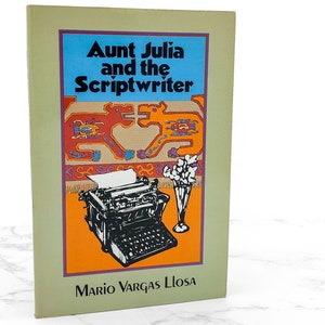 May include: A book titled "Aunt Julia and the Scriptwriter" by Mario Vargas Llosa. The cover features a blue background with white text, orange and purple accents, and an illustration of a typewriter and flowers.