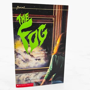 May include: A paperback book titled The Fog by Caroline B. Cooney with a cover illustration of a person looking out a window at a foggy landscape. The title is in large, bright green letters, and the text reads No one had told her the fog could kill.