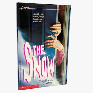 May include: A paperback book titled The Snow by Caroline B. Cooney. The cover features a dark blue scene with a door slightly ajar, revealing two hands reaching through the opening. The title is written in large, dripping white letters.