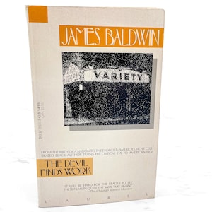 May include: A paperback book titled "The Devil Finds Work" by James Baldwin. The cover features the word "Variety" above a black and white image. The book has a white background with orange and black text.