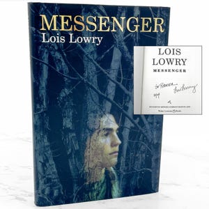 May include: A hardcover book titled "MESSENGER" by Lois Lowry. The cover features a portrait of a person and a dark blue background with tree branches. The book's title and author's name are in gold lettering. An insert shows the title page with an inscription.