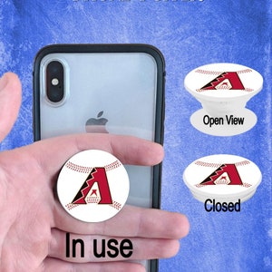 May include: White phone pop socket with a red baseball logo. The logo is a stylized "A" with a baseball stitch design. The pop socket is in the open and closed position. The text "Open View" and "Closed" are below the pop sockets. The text "In use" is below the pop socket on the phone.