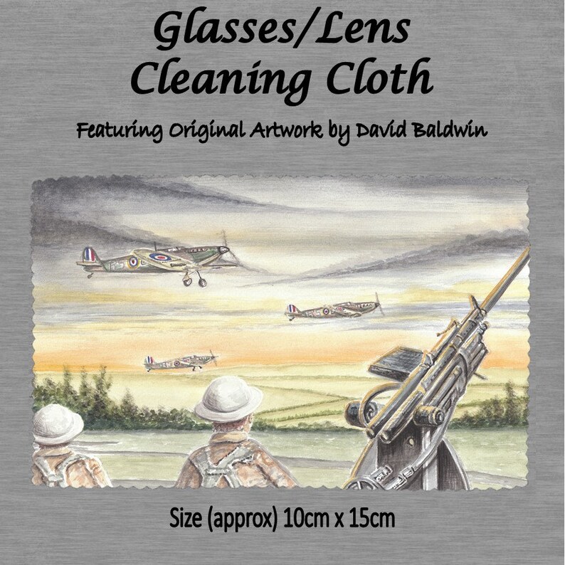 May include: A microfiber cleaning cloth featuring an original watercolor painting of a World War II scene. The painting depicts three British fighter planes flying over a field with a gun emplacement in the foreground. The text "Glasses/Lens Cleaning Cloth" and "Featuring Original Artwork by David Baldwin" is printed on the cloth. The cloth measures approximately 10 cm by 15 cm.