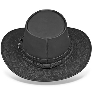 Op de afbeelding: Een zwarte leren cowboyhoed met een gevlochten band en een reli&euml;fpatroon met bloemen.