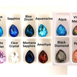May include: Assortment of pearlescent teardrop-shaped glass beads in various colors, including aqua, sapphire, blue zircon, aquamarine, light violet, clear crystal, montana sapphire, amethyst, black diamond, and peach.