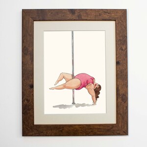 May include: A framed illustration of a person in a pink leotard performing a pole dance move. The person is upside down with their legs extended and their arms bent, holding onto the pole. The illustration is done in a cartoon style with a white background.