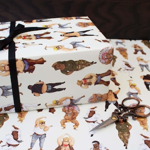 May include: Gift wrap featuring a repeating pattern of illustrated figures in various outfits and poses. The gift box is wrapped with a black ribbon. A pair of decorative scissors rests on the wrapping paper.