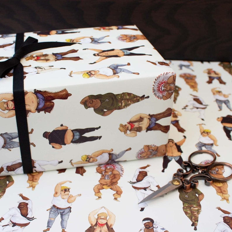 May include: Gift wrap featuring a repeating pattern of illustrated figures in various outfits and poses. The gift box is wrapped with a black ribbon. A pair of decorative scissors rests on the wrapping paper.