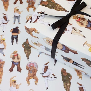 May include: White wrapping paper featuring a repeating pattern of illustrated figures in various outfits, including a cowboy, a martial artist, and a construction worker. The wrapped gift is tied with a black ribbon.