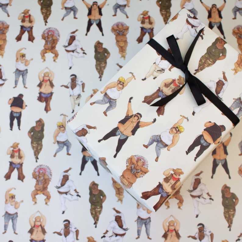 May include: Gift wrap featuring a repeating pattern of illustrated figures in various outfits, including cowboys, construction workers, and Native American attire. The wrapped gift is tied with a black ribbon, and the background is the same patterned paper.