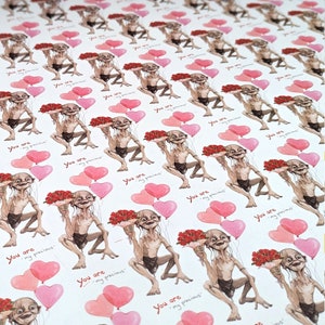 May include: Wrapping paper with a repeating pattern of a cartoon character holding flowers and heart-shaped balloons. The text "You are my precious" is printed in red on the white background.