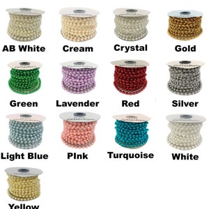 May include: Assortment of spools of pearl beads in various colours, including white, cream, crystal, gold, green, lavender, red, silver, light blue, pink, turquoise, and yellow.