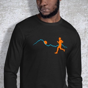May include: Black long-sleeved t-shirt featuring a graphic of a person running in front of a mountain range with a sun setting behind the mountains. The text "SNARKY SWAG" is in the top right corner of the image.