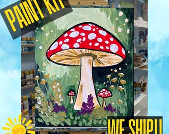 May include: A painted canvas featuring a large red mushroom with white spots, set against a green and gold background. The words "PAINT KIT" and "WE SHIP!!" are displayed in yellow text. The painting is on an easel.