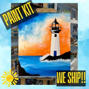 May include: A paint kit featuring a canvas with a lighthouse painting. The lighthouse is white with a black top, set against a vibrant orange and blue sky and ocean. The words "PAINT KIT" are in a yellow banner.