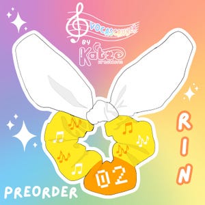 May include: A yellow and orange scrunchie with musical notes printed on it. The scrunchie has a white bow on top and the text "02" in a white box on the front. The text "PREORDER" is in the bottom left corner and the text "RIN" is in the bottom right corner. The text "VOCASCRUNCH by Katze Kreations" is in the top center of the image.