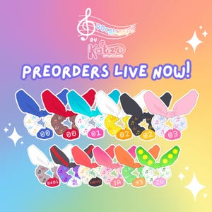 May include: A set of 12 colorful hair scrunchies with a musical note design. Each scrunchie has a different color and a number or text on it. The scrunchies are arranged in two rows. The text "PREORDERS LIVE NOW!" is at the top of the image.