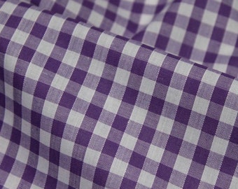 May include: Purple and white gingham fabric with a subtle texture. The fabric is folded in half, showing the pattern.