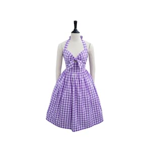 May include: A purple and white gingham halter dress with a bow at the neckline.