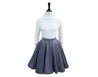 May include: A gray, full circle skirt with a white turtleneck sweater on a mannequin.